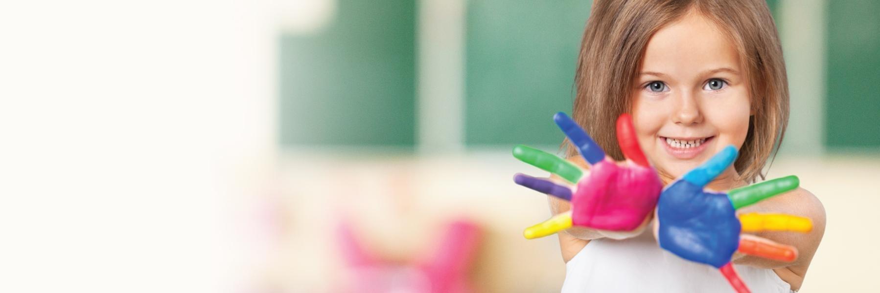 Children's dentistry patient with paint on her hands in 27502